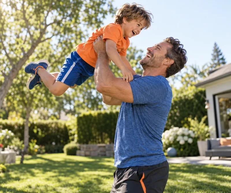 Dad lifting his son in the backyard